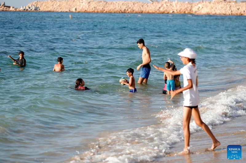 People cool off on a beach along the Mediterranean coast during a heatwave in Alexandria, Egypt, Aug. 22, 2026. (Xinhua/Ahmed Gomaa)
