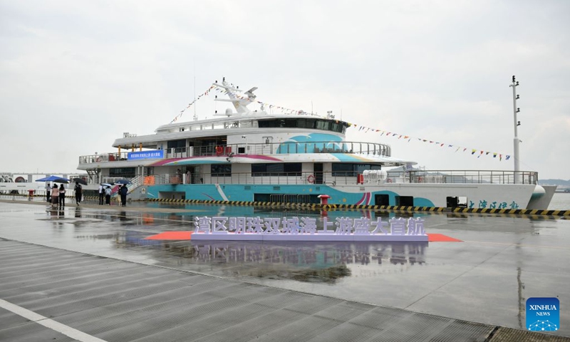 The cruise ship Da Wan Qu Yi Dun docks at the Nansha International Cruise Home Port in Guangzhou, south China's Guangdong Province, Aug. 22, 2026. Named after the Greater Bay Area, known in Chinese as Da Wan Qu, the cruise ship Da Wan Qu Yi Dun departed from the Nansha International Cruise Home Port in Guangzhou on Saturday, marking the official launch of the regular Guangzhou-Shenzhen maritime cultural tourism route.
Sailing past the Hong Kong-Zhuhai-Macao Bridge, the Shenzhen-Zhongshan Link and 16 landmarks of the Greater Bay Area, the ship also provided visitors with diverse onboard experiences including performances themed on intangible cultural heritage and magic shows. Photo: Xinhua