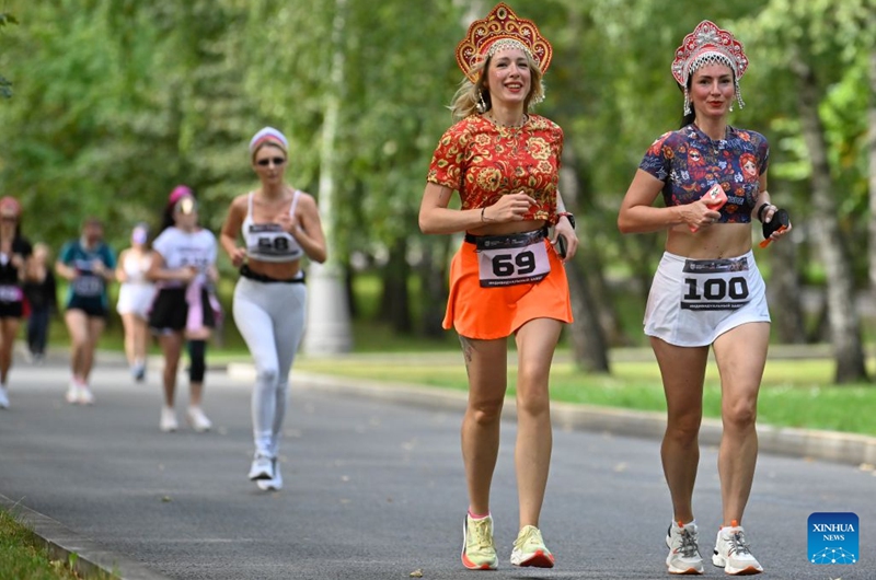 Women wearing traditional Russian headdress participate in a running activity at the Russian Field Art Festival at Victory Park in Moscow, Russia, on Aug. 22, 2026. The 15th Russian Field Art Festival kicked off at Victory Park in Moscow, Russia, on Aug. 22. (Photo by Alexander Zemlianichenko Jr/Xinhua)