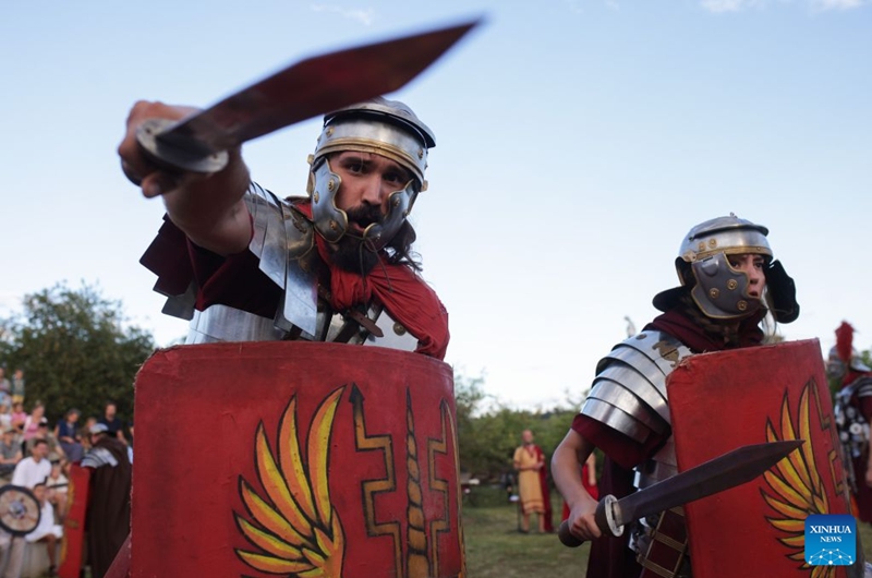 Participants dressed as Roman soldiers present military skills during the Roman Games Festival in Ptuj, Slovenia, Aug. 22, 2026. The 19th edition of the Roman Games festival kicked off on Friday in Ptuj and will last till Aug. 23. (Photo by Zeljko Stevanic/Xinhua)
