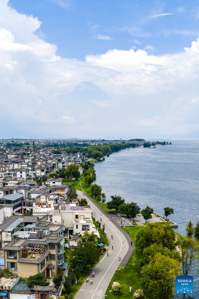 An aerial drone photo shows people cycling along the Erhai Lake ecological corridor in Dali, southwest China's Yunnan Province, Aug. 21, 2026. Photo: Xinhua