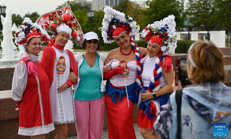 Women wearing traditional Russian headdress pose for a photo at the Russian Field Art Festival at Victory Park in Moscow, Russia, on Aug. 22, 2026. The 15th Russian Field Art Festival kicked off at Victory Park in Moscow, Russia, on Aug. 22. (Photo by Alexander Zemlianichenko Jr/Xinhua)