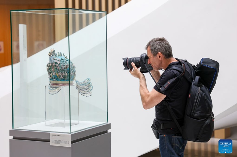 A member of a joint China-Russia media delegation takes photos of an exhibit at the China National Silk Museum in Hangzhou, east China's Zhejiang Province, Aug. 20, 2026. The delegation visited Hangzhou from Aug. 20 to 22, experiencing the charm of Chinese culture. (Xinhua/Jiang Han)