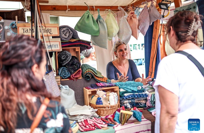 People visit the Festival of Folk Arts at Buda Castle in Budapest, Hungary, Aug. 21, 2026. The annual festival showcases traditional Hungarian crafts and folk art as part of the celebration of Hungarian cultural heritage. (Photo by David Balogh/Xinhua)