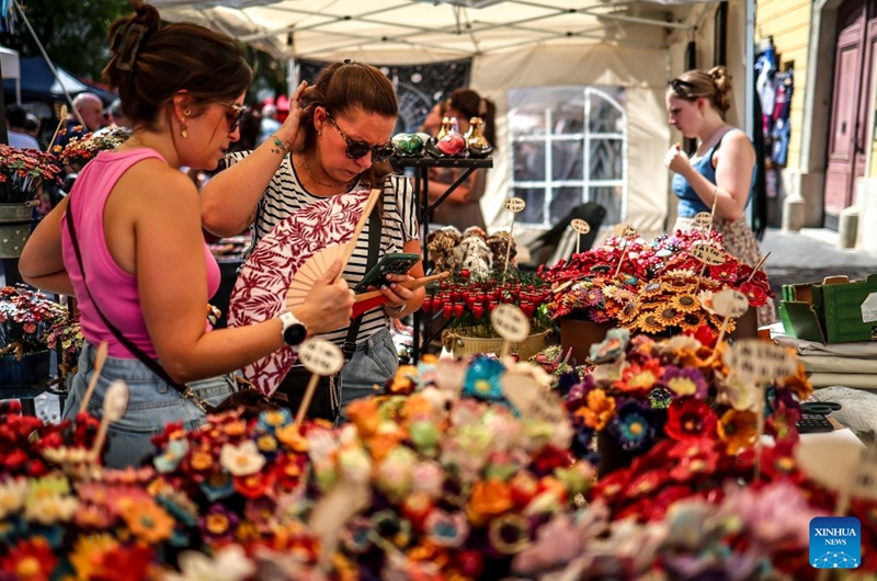 People visit the Festival of Folk Arts at Buda Castle in Budapest, Hungary, Aug. 21, 2026. The annual festival showcases traditional Hungarian crafts and folk art as part of the celebration of Hungarian cultural heritage. (Photo by David Balogh/Xinhua)