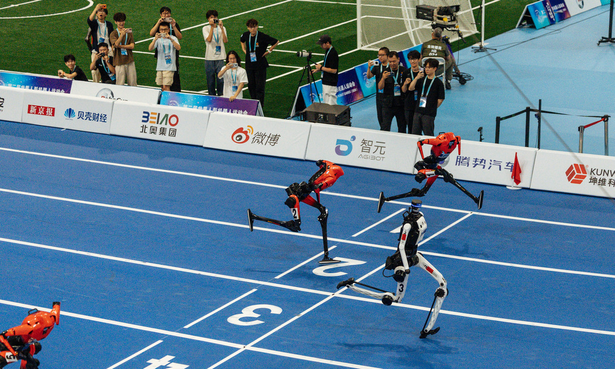 At the second WHRG, in the 100-meter semifinal of the large-size humanoid robot category, the Tiangong humanoid robot (center) from Beijing Humanoid Robot Innovation Center clocked a new personal best of 8.86 seconds, breaking the record again. Photo: Li Hao/GT