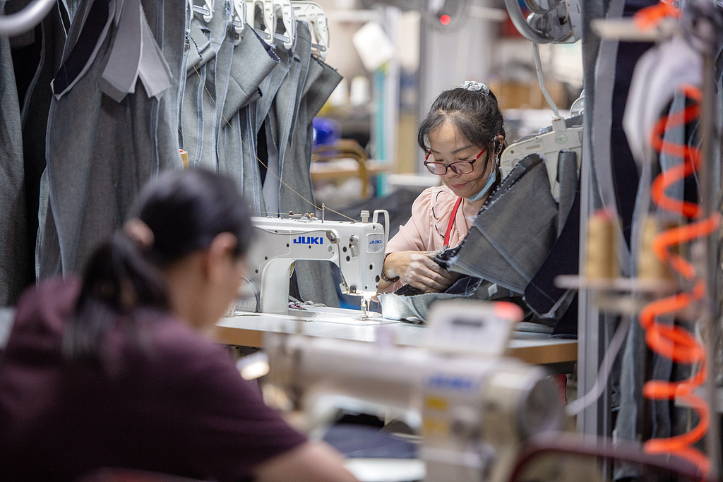 Workers are busy fulfilling orders for denim clothing at an automated workshop in Changxing, East China's Zhejiang Province, on August 25, 2026. The company's monthly jeans output has exceeded 90,000 pieces, and production is already booked through December. More than 90 percent of its products are exported to markets including France, South Korea and the US. Photo: VCG