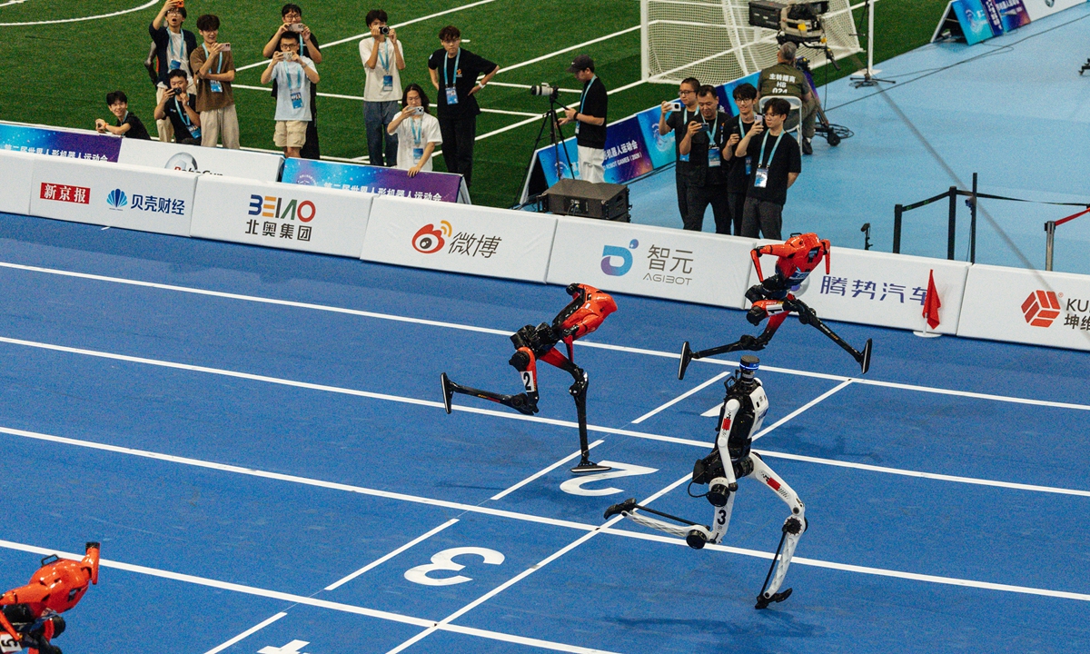 At the second World Humanoid Robot Games on August 25, 2026, in the 100-meter semifinal of the large-size humanoid robot category, the Tiangong humanoid robot (center) from Beijing Humanoid Robot Innovation Center clocks a performance of 8.86 seconds, breaking the record again. Photo: Li Hao/GT