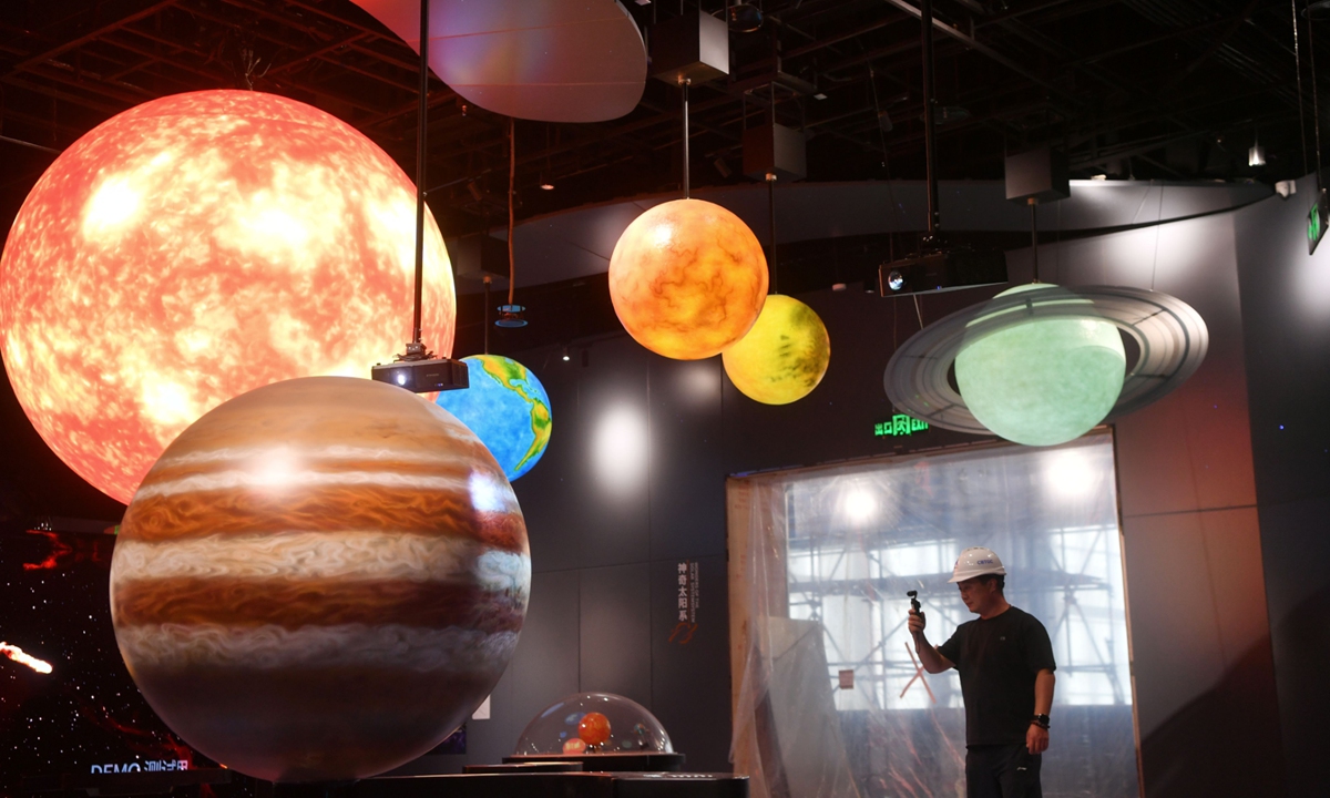 A staff member shoots video inside the Beijing Future Science and Technology Museum on August 25, 2026. Set to officially open to the public on September 30, the venue serves as a new comprehensive popular?science education hub integrating sci?tech exhibitions, research?oriented practice and innovation exploration. Photo: VCG