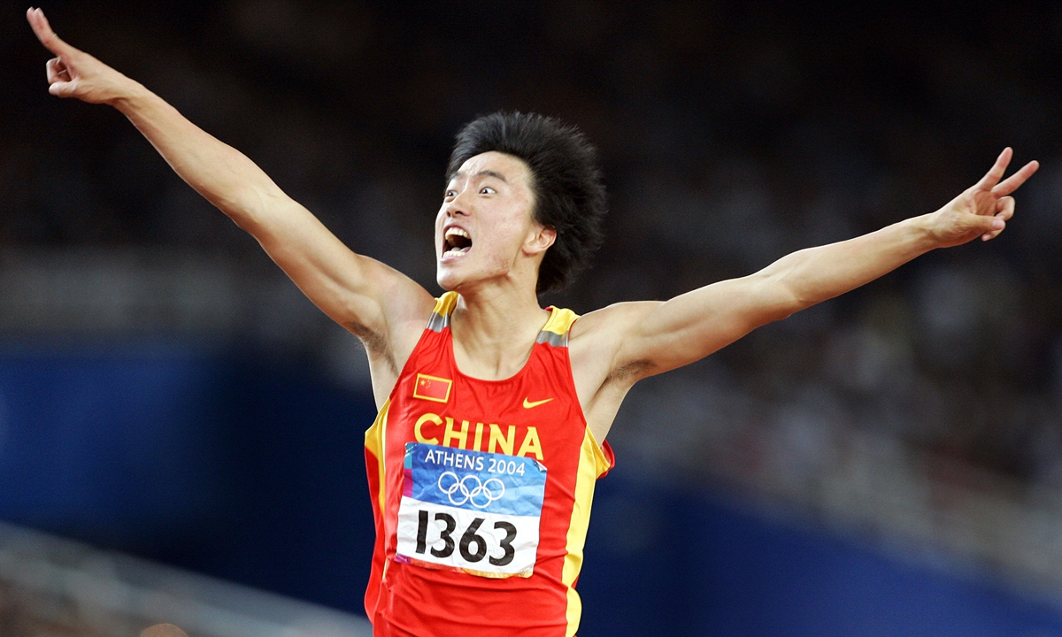 China's Liu Xiang celebrates as he crosses the finish line to win the men's 110 hurdles final at the 2004 Olympic Games on August 27, 2004 in Athens, Greece.  Photo: VCG