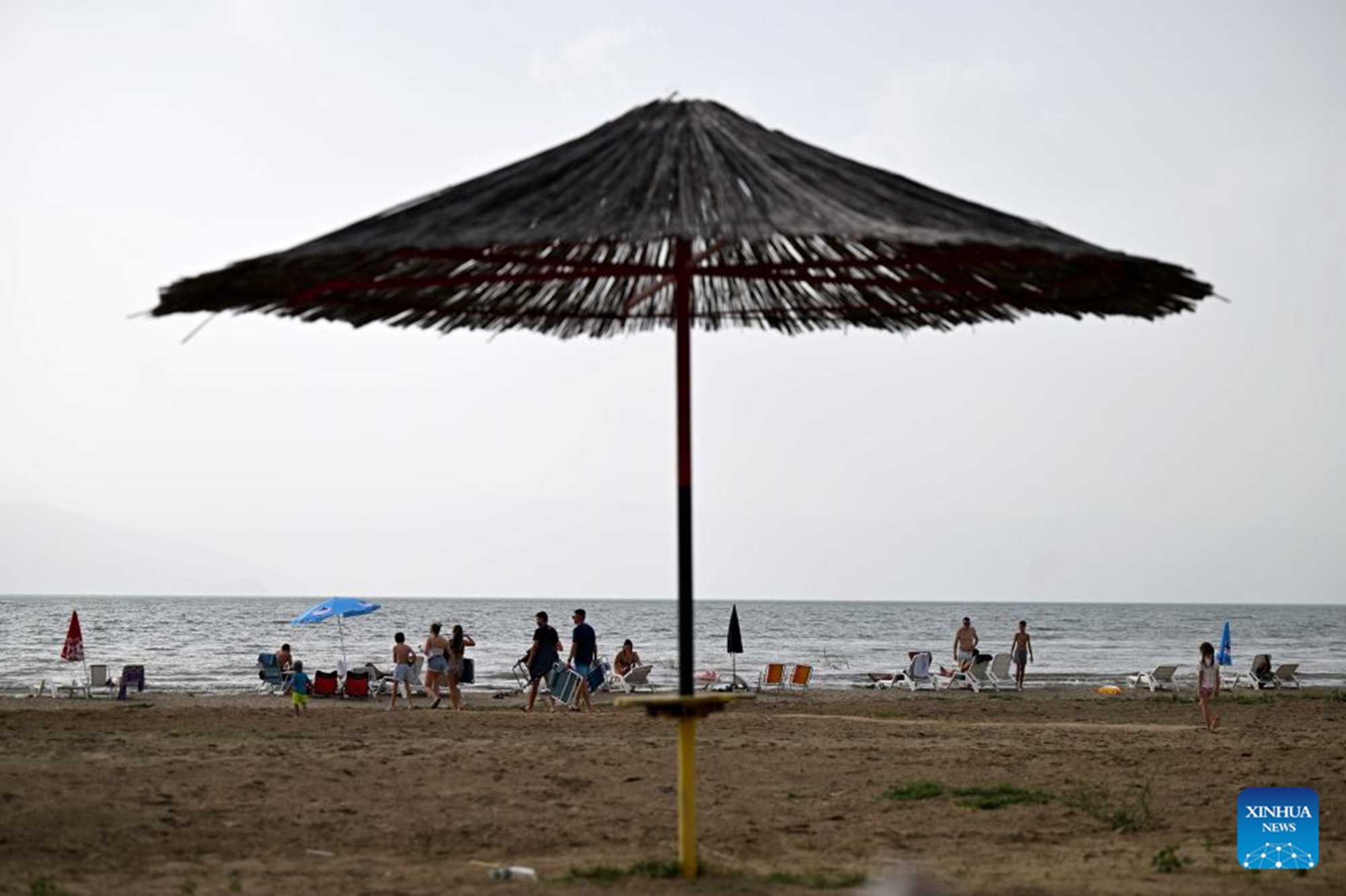 People enjoy themselves at the shore of Prespa Lake, Resen, North Macedonia, Aug. 28, 2026. Temperatures soar as a heatwave grips the region, with hot summer conditions prevailing across the area. (Photo by Tomislav Georgiev/Xinhua)
