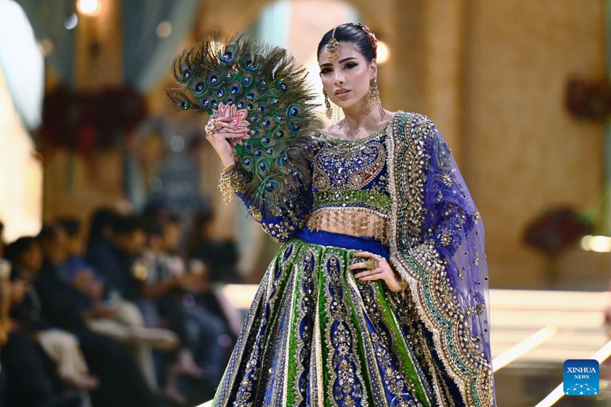 A model presents a bridal creation during a fashion show in southern Pakistani port city of Karachi on Aug. 28, 2026. (Str/Xinhua)