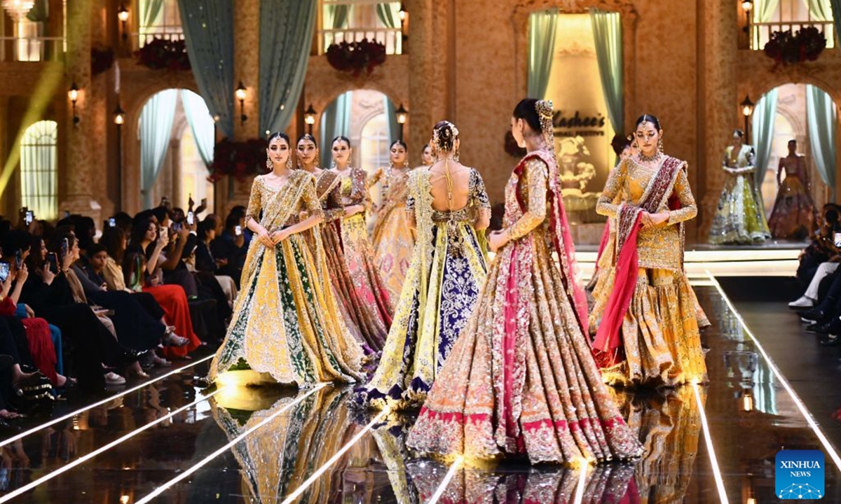Models present bridal creations during a fashion show in southern Pakistani port city of Karachi on Aug. 28, 2026. (Str/Xinhua)