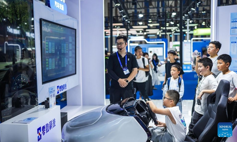 Children get hands-on experience with a smart driving simulator at the 2026 China International Big Data Industry Expo in Guiyang, southwest China's Guizhou Province, Aug. 28, 2026. The expo kicked off here on Friday, showcasing the cutting-edge technologies in several key sectors including computing power infrastructure, data supply, model-driven innovation, security safeguards, and intelligent experiences. Photo: Xinhua