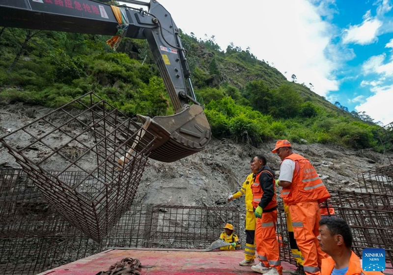 Gabion baskets are unloaded at the mudslide-hit areas in Gyirong County, southwest China's Xizang Autonomous Region, Aug. 29, 2026. Staff members stepped up efforts on Saturday to install rock-filled gabion baskets along roadsides to keep falling rocks and debris out of roadways in the mudslide-hit area. (Xinhua/Jigme Dorje)