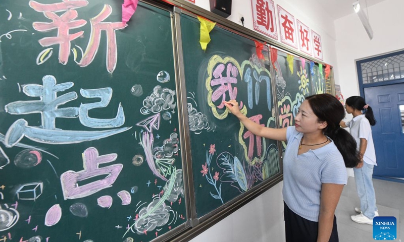 Teachers decorate a blackboard at a middle school in Xinle, north China's Hebei Province, Aug. 29, 2026. Various departments across the country are getting ready for the upcoming new semester. (Photo by Jia Minjie/Xinhua)