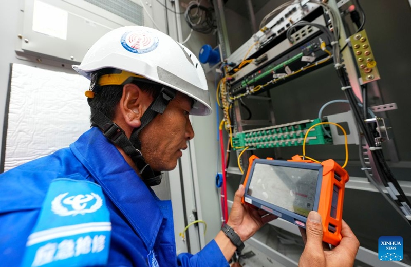 A staff member tests fiber-optic cables in Gyirong Town, southwest China's Xizang Autonomous Region, Aug. 29, 2026. The telecommunication sector has been making all-out efforts to restore the communication infrastructure affected by the mudslide in Gyirong, and to ensure unimpeded emergency communications. So far, one base station has been restored, and 3 new base stations have been built. (Xinhua/Jigme Dorje)