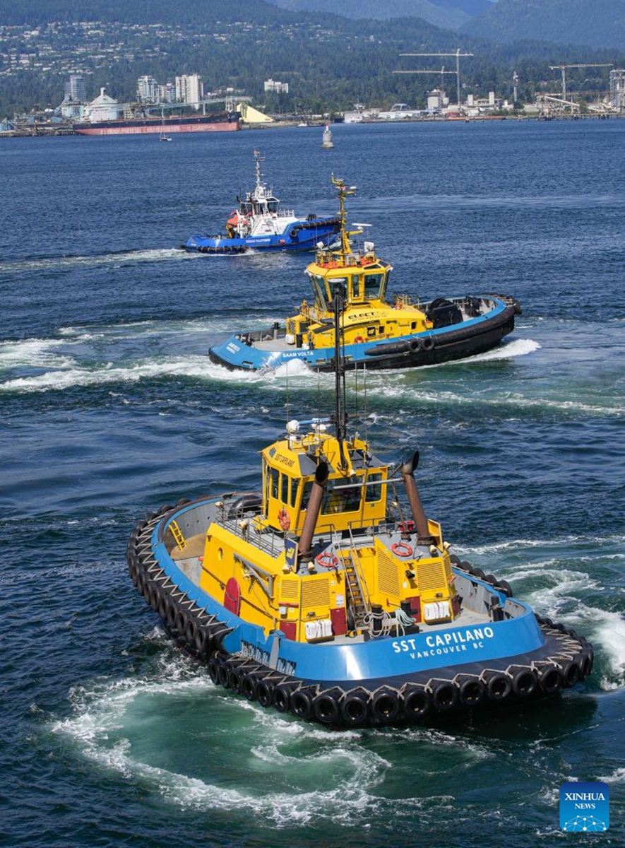 Tugboats maneuver during a marine demonstration at the Port Day event in Vancouver, British Columbia, Canada, Aug. 29, 2026. The annual event showcased the local maritime industry and its role in moving Canadian trade, featuring marine demonstrations and interactive exhibits that allowed the public to learn about local port operations and safety practices. (Photo by Liang Sen/Xinhua)