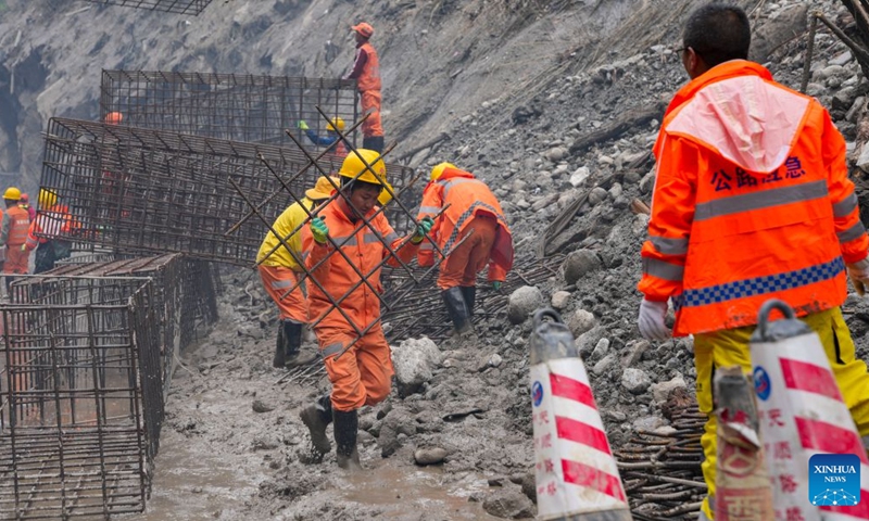 Staff members move gabion baskets at the mudslide-hit areas in Gyirong County, southwest China's Xizang Autonomous Region, Aug. 29, 2026. Staff members stepped up efforts on Saturday to install rock-filled gabion baskets along roadsides to keep falling rocks and debris out of roadways in the mudslide-hit area. (Xinhua/Jigme Dorje)