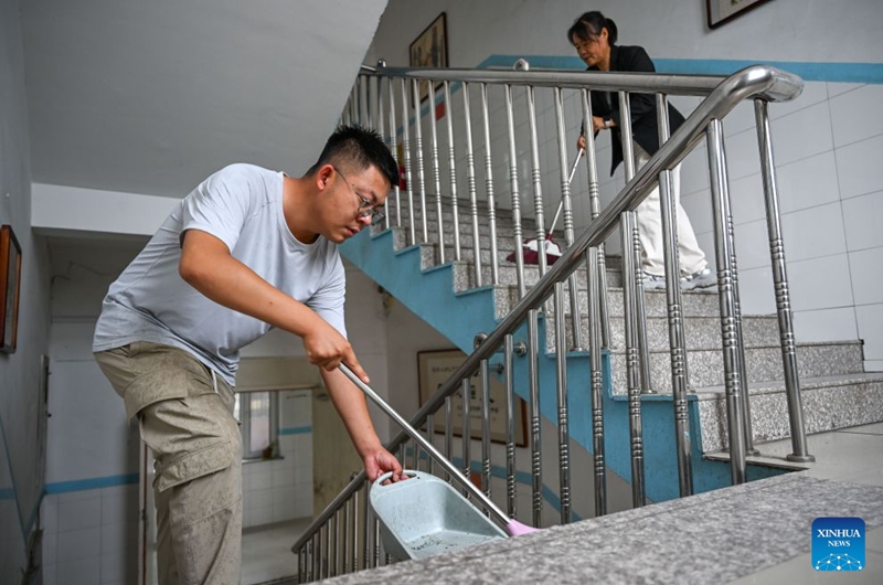 Staff members clean the stairs at a primary school in Zhalantun City of north China's Inner Mongolia Autonomous Region, Aug. 29, 2026. Various departments across the country are getting ready for the upcoming new semester. (Xinhua/Bei He)