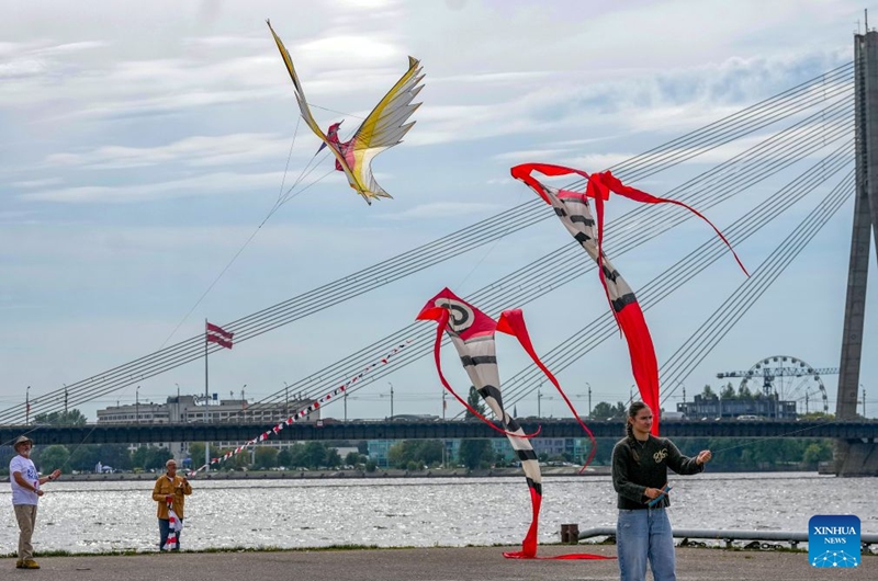 People fly kites during the Riga International Kite Festival in Riga, Latvia, Aug. 29, 2026. (Photo by Edijs Palens/Xinhua)