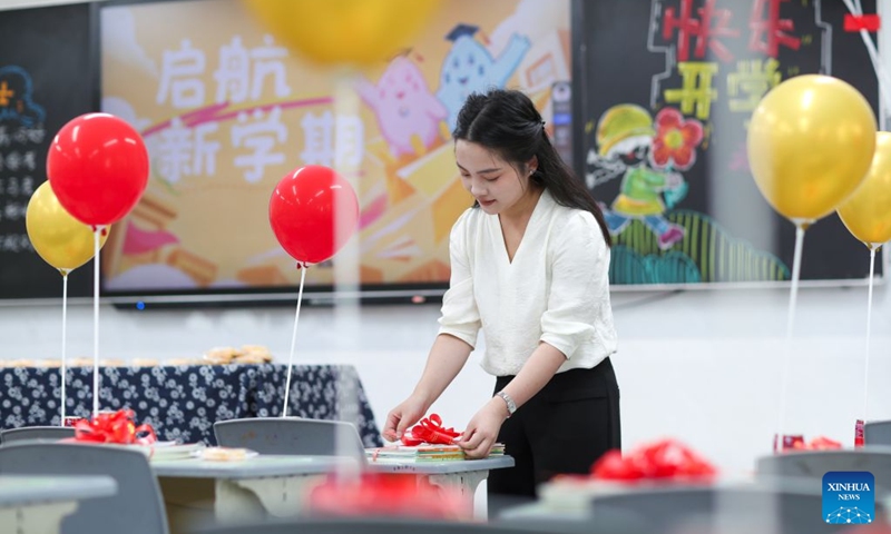 A teacher decorates a classroom at a primary school in Taizhou, east China's Jiangsu Province, Aug. 28, 2026. Various departments across the country are getting ready for the upcoming new semester. (Photo by Zhou Shegen/Xinhua)