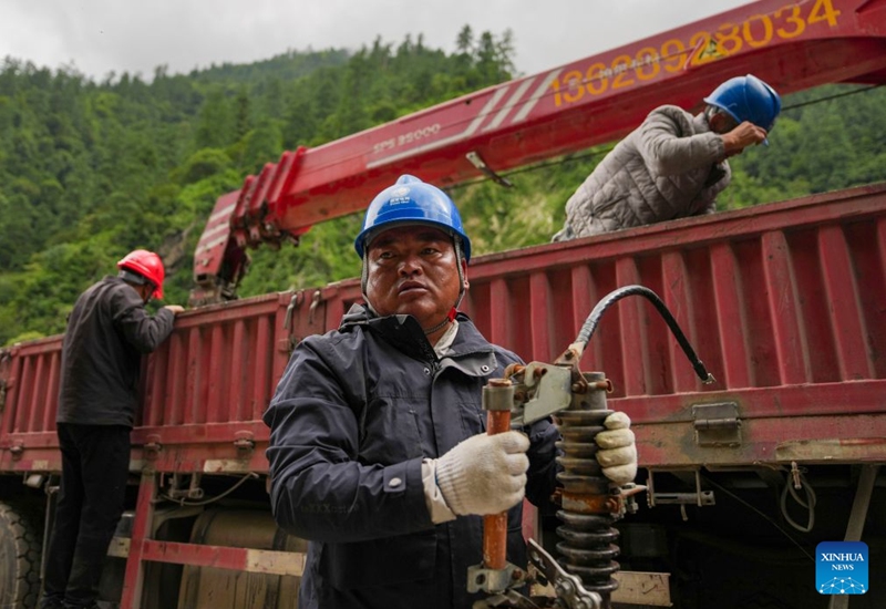 A staff member transfers components of a transformer about 3 kilometers from mudslide-hit Gyirong Port in Gyirong County, southwest China's Xizang Autonomous Region, Aug. 29, 2026. Staff members of the local power company has set up an emergency power transformer not far from the mudslide-hit Gyirong Port, as part of their efforts to ensure power supply for all rescue operations. Power supply is gradually restored in the mudslide-hit areas. (Xinhua/Jigme Dorje)