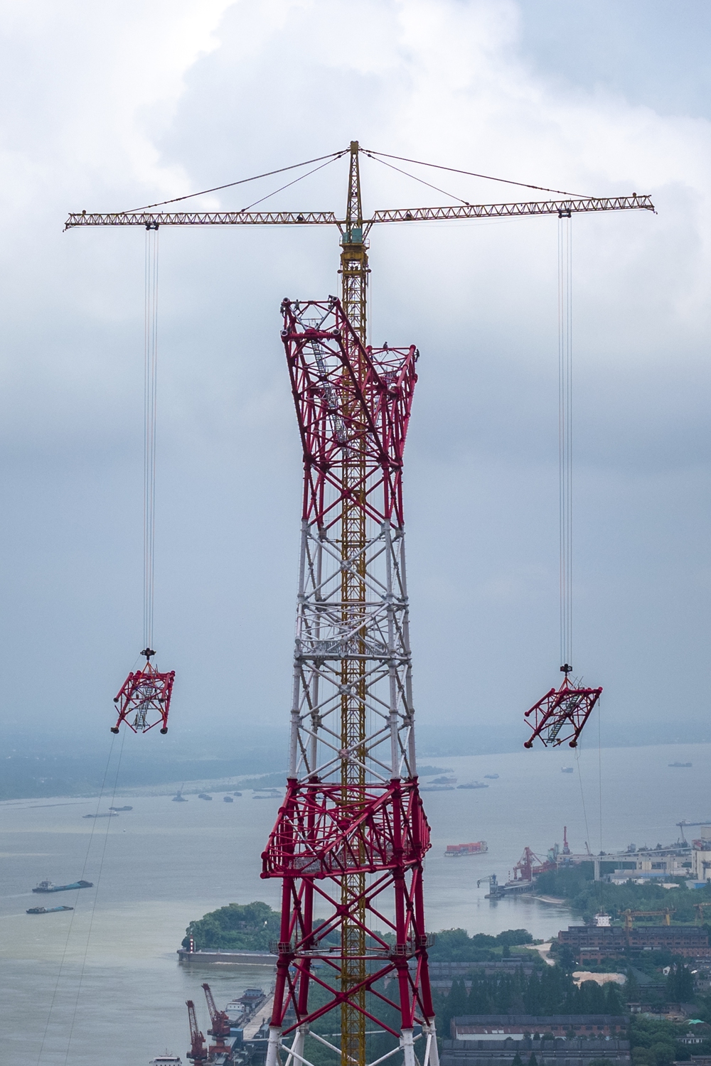 Construction workers carry out capping?off operations on the south tower of the Gansu?Zhejiang UHVDC Yangtze River crossing transmission tower in Wuhu, East China's Anhui Province, on August 30, 2026. A key project in China's west-to-east power transmission program, the project runs from Wuwei in Gansu Province to Shaoxing in Zhejiang Province, spanning 2,370 kilometers. Photo: VCG