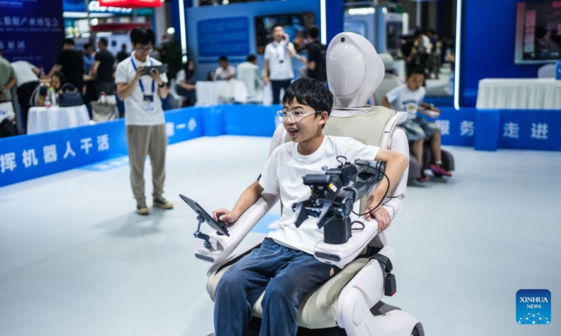 Children try smart robots for assisted mobility at the 2026 China International Big Data Industry Expo in Guiyang, southwest China's Guizhou Province, Aug. 28, 2026. The expo kicked off here on Friday, showcasing the cutting-edge technologies in several key sectors including computing power infrastructure, data supply, model-driven innovation, security safeguards, and intelligent experiences. Photo: Xinhua