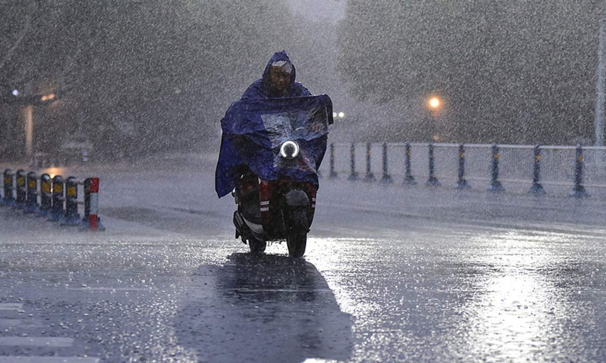 A resident in Fuyang, East China's Anhui Province, travels through heavy rain on August 30, 2026. The city experienced severe rainfall that day under the influence of the remnants of Typhoon Saudel.  Photo: VCG