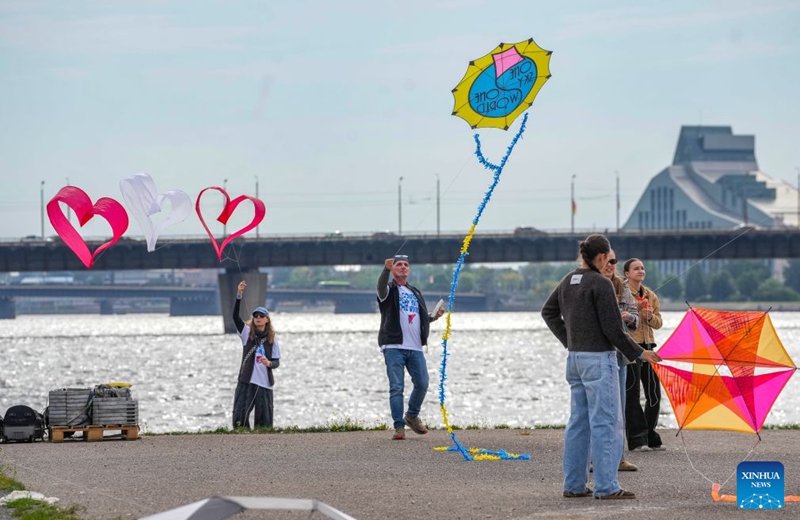 People fly kites during the Riga International Kite Festival in Riga, Latvia, Aug. 29, 2026. (Photo by Edijs Palens/Xinhua)