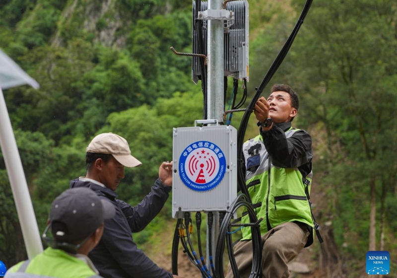 Staff members work on a signal base station in Gyirong Town, southwest China's Xizang Autonomous Region, Aug. 29, 2026. The telecommunication sector has been making all-out efforts to restore the communication infrastructure affected by the mudslide in Gyirong, and to ensure unimpeded emergency communications. So far, one base station has been restored, and 3 new base stations have been built. (Xinhua/Jigme Dorje)