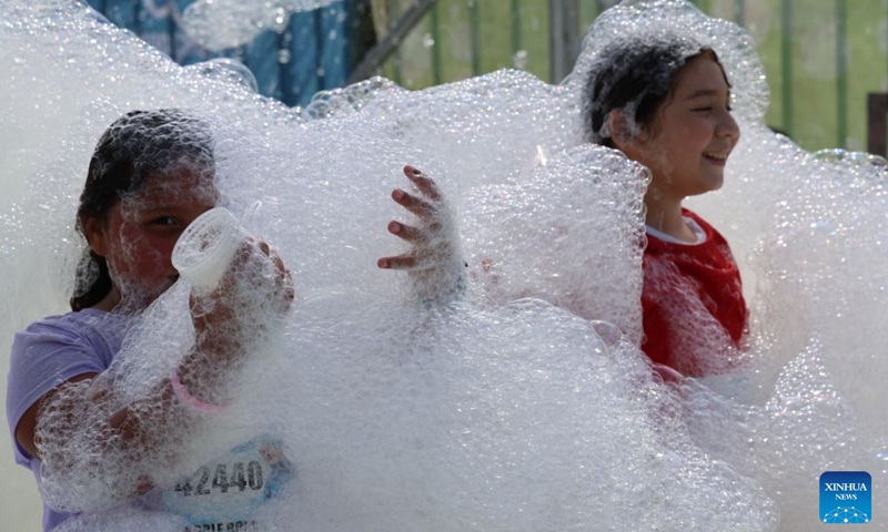 Children participate in the Bubble Run in Pomona, Los Angeles County, California, the United States, Aug. 29, 2026. More than 10,000 people took part in the annual Bubble Run on Saturday at the Pomona Fairplex in Pomona, east of Los Angeles, enjoying a day of running, colorful bubbles and family fun. (Photo by Zeng Hui/Xinhua)