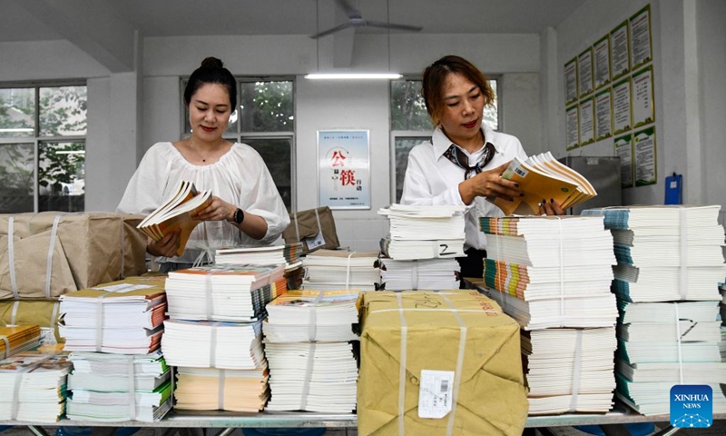 Teachers check the textbooks for the upcoming new semester at a primary school in Jiyuan, central China's Henan Province, Aug. 28, 2026. Various departments across the country are getting ready for the upcoming new semester. (Photo by Miao Qiunao/Xinhua)