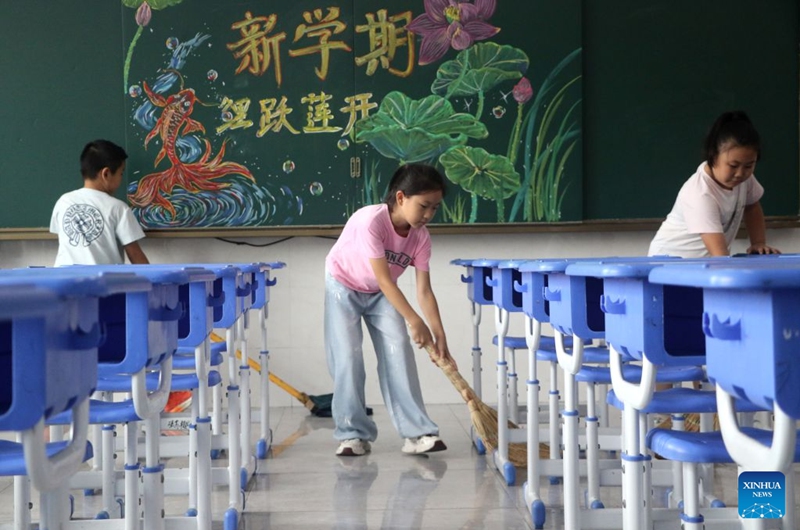 Students clean a classroom at a primary school in Gaomi, east China's Shandong Province, Aug. 28, 2026. Various departments across the country are getting ready for the upcoming new semester. (Photo by Li Haitao/Xinhua)