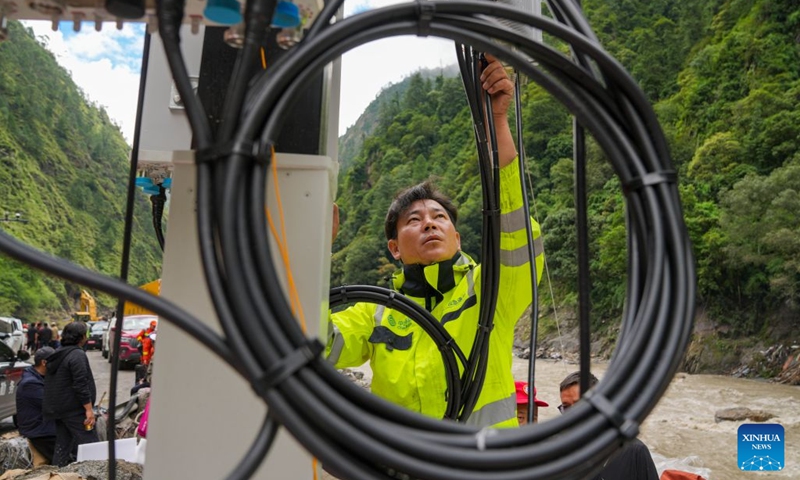 A staff member works on a base station in Gyirong Town, southwest China's Xizang Autonomous Region, Aug. 29, 2026. The telecommunication sector has been making all-out efforts to restore the communication infrastructure affected by the mudslide in Gyirong, and to ensure unimpeded emergency communications. So far, one base station has been restored, and 3 new base stations have been built. (Xinhua/Jigme Dorje)