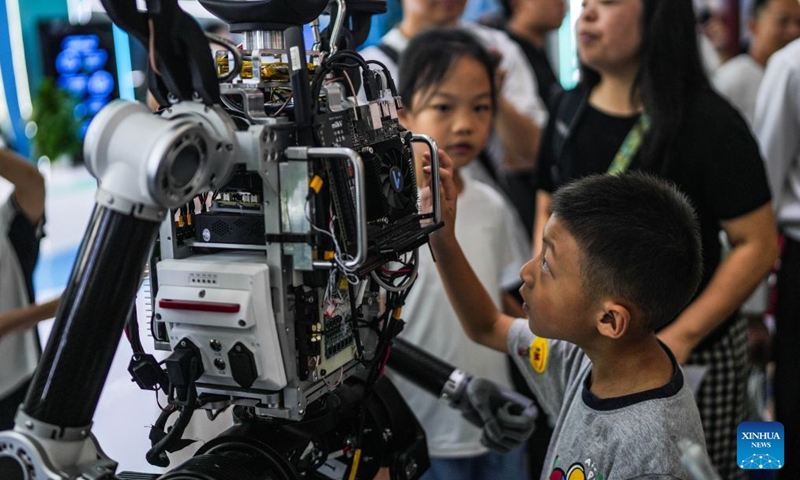 A boy learns about the internal structure of a robot with its covering parts removed at the 2026 China International Big Data Industry Expo in Guiyang, southwest China's Guizhou Province, Aug. 28, 2026. The expo kicked off here on Friday, showcasing the cutting-edge technologies in several key sectors including computing power infrastructure, data supply, model-driven innovation, security safeguards, and intelligent experiences. Photo: Xinhua