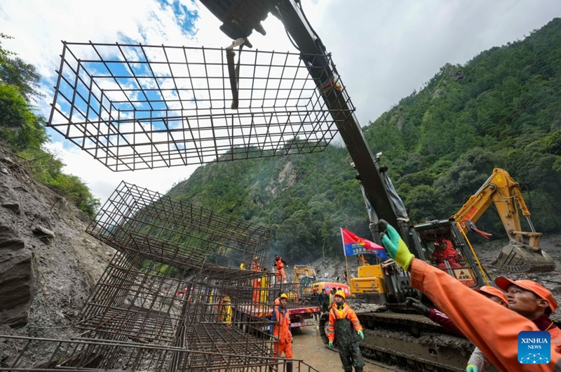 Gabion baskets are unloaded at the mudslide-hit areas in Gyirong County, southwest China's Xizang Autonomous Region, Aug. 29, 2026. Staff members stepped up efforts on Saturday to install rock-filled gabion baskets along roadsides to keep falling rocks and debris out of roadways in the mudslide-hit area. (Xinhua/Jigme Dorje)