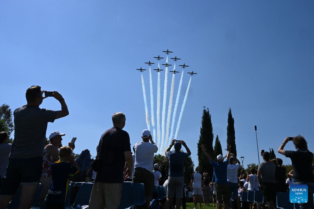 People watch the Italian Frecce Tricolori aerobatic squad performing during an airshow flying over Lake Garda, Brescia, Italy, Sept. 4, 2026. (Photo: Xinhua)