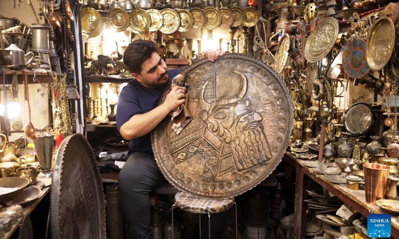 A man cleans a copper item at Souk al-Safafeer, a traditional copper market, in Baghdad, Iraq, on Sept. 5, 2026. (Photo: Xinhua)