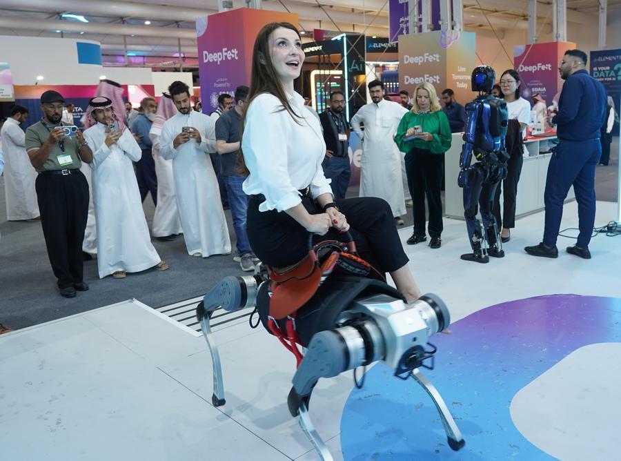A visitor rides a quadruped robot of AGIQUAD at the LEAP 2026 Tech Conference in Riyadh, Saudi Arabia, Sept. 2, 2026. (Photo: Xinhua)