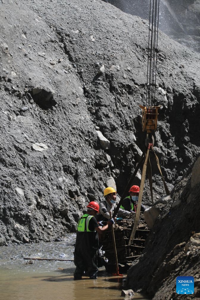 Workers load stones for road-reinforcement at the core affected zone of the mudslide-hit Gyirong Port in southwest China's Xizang Autonomous Region, Sept. 5, 2026. More rescue forces have entered the core affected zone of the mudslide-hit Gyirong Port on Saturday. China Railway Group Limited have provided steel gabions to the site for road-reinforcement. (Photo: Xinhua)