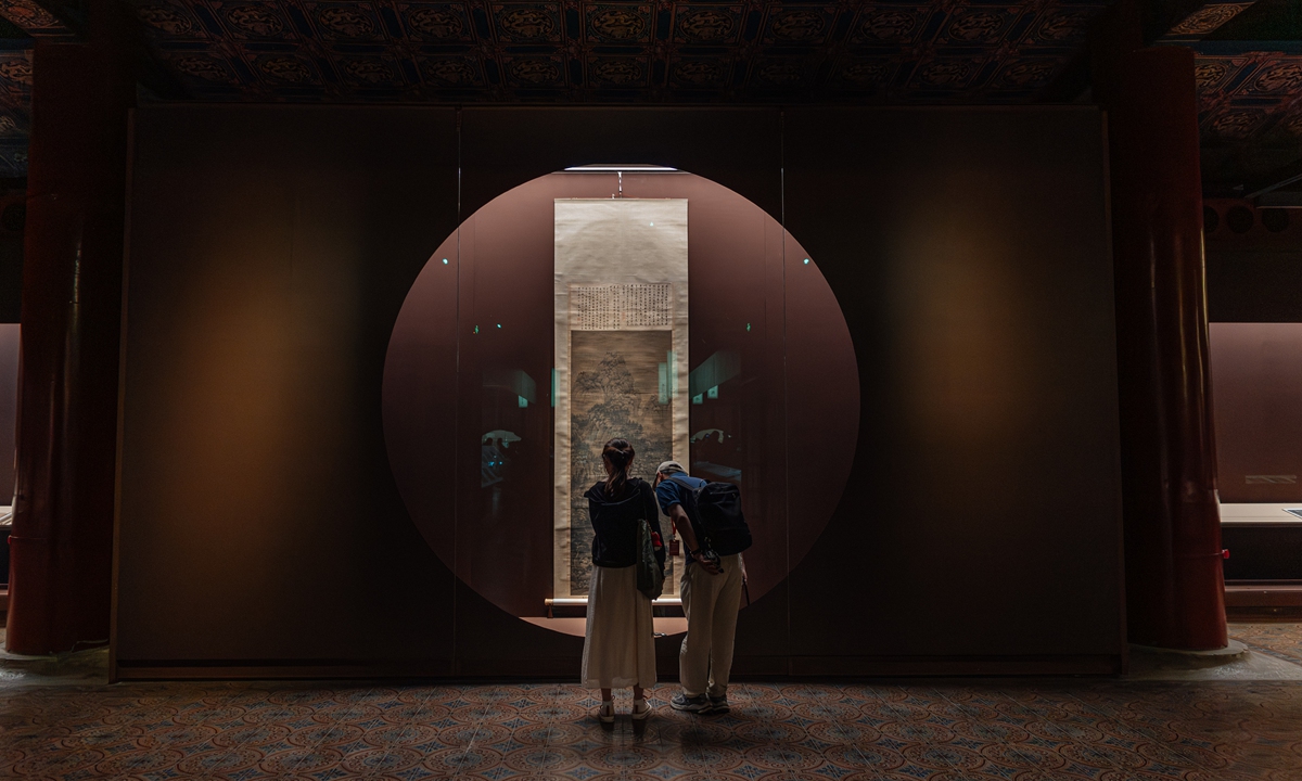 Visitors observe an ancient painting during an exhibition of Tang (618-907) and Song (960-1279) dynasties' calligraphy and painting works at the Palace Museum in Beijing on August 31, 2026. The exhibition, which runs to November 1, brings together 107 works of calligraphy and painting from the museum's permanent collection, 24 of which have not been publicly displayed in nearly 30 years. Photo: Li Hao/GT