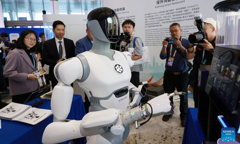 Visitors watch a robot making coffee during the Asia-Pacific Media Forum in Shenzhen, south China's Guangdong Province, Sept. 5, 2026. The Asia-Pacific Media Forum opened on Saturday in Shenzhen, with the theme of Building a Path to Shared Prosperity for the Asia-Pacific Community: Media Consensus and Action. The forum held an exhibition of scientific and technological innovation achievements, mainly showcasing cutting-edge innovation achievements in Guangdong Province, especially in Shenzhen. (Photo: Xinhua)