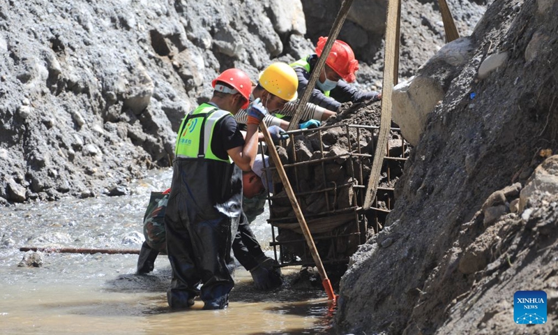 Workers load stones for road-reinforcement at the core affected zone of the mudslide-hit Gyirong Port in southwest China's Xizang Autonomous Region, Sept. 5, 2026. More rescue forces have entered the core affected zone of the mudslide-hit Gyirong Port on Saturday. China Railway Group Limited have provided steel gabions to the site for road-reinforcement. (Photo: Xinhua)
