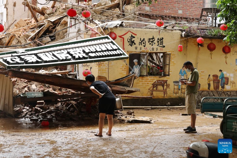 Staff members check the damaged buildings in Huating Town of Putian City, southeast China's Fujian Province, Sept. 5, 2026. As this round of heavy rainfall in Putian concluded on Saturday, floodwaters gradually receded in areas including Huating Town, which had been severely inundated by Typhoon Saudel. Local authorities have since shifted to post-disaster recovery, undertaking tasks including road clearance, water and power restoration, environmental dredging, and the resettlement of affected residents. (Photo: Xinhua)