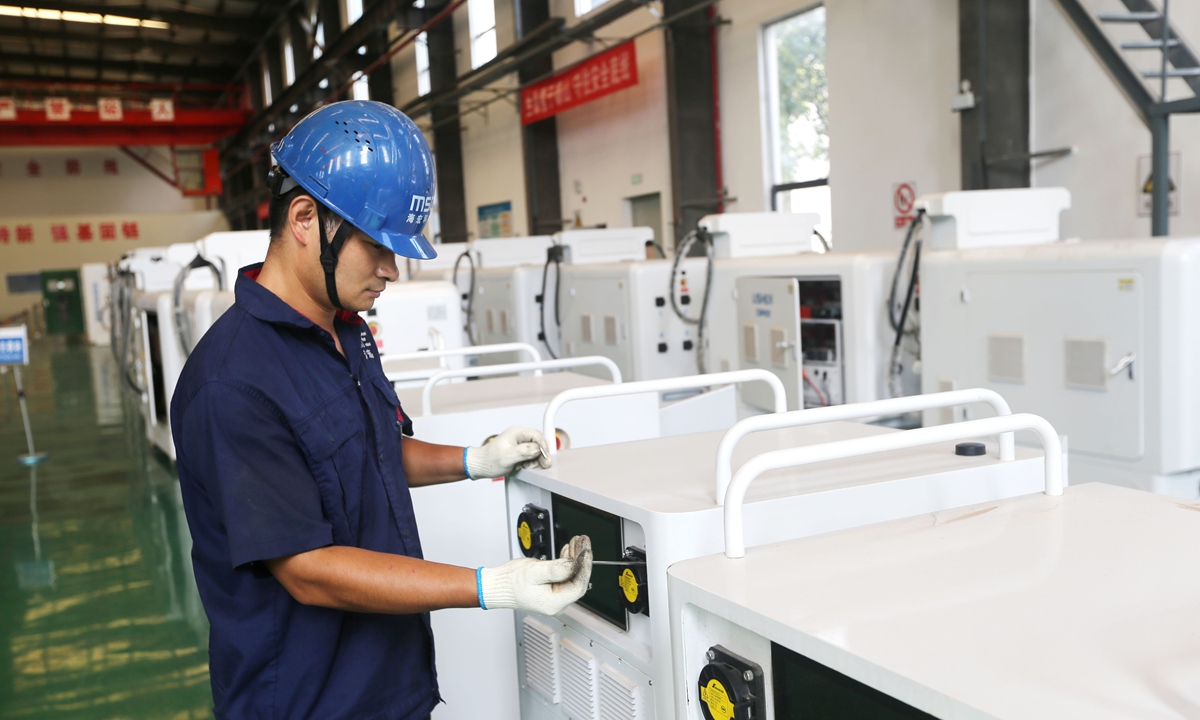 A worker assembles mobile energy storage intelligent charging robots at a plant in Lianyungang, East China's Jiangsu Province on August 31, 2026. Each robot is equipped with a lithium-iron phosphate energy storage battery cell, capable of delivering fast charging of up to 80 kilowatts. Photo: VCG
