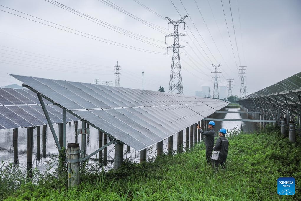 Staff members of State Grid Huzhou power supply company conduct inspection on the photovoltaic lines and equipment at a photovoltaic power station in Changxing County of Huzhou City, east China's Zhejiang Province, May 27, 2026. In recent years, State Grid Huzhou power supply company has been constantly promoting the upgrading of the county-level power grids, advancing the integration of renewable energy sources into power grids, and endeavoring to construct a safer, greener and smarter power grid. (Photo: Xinhua)