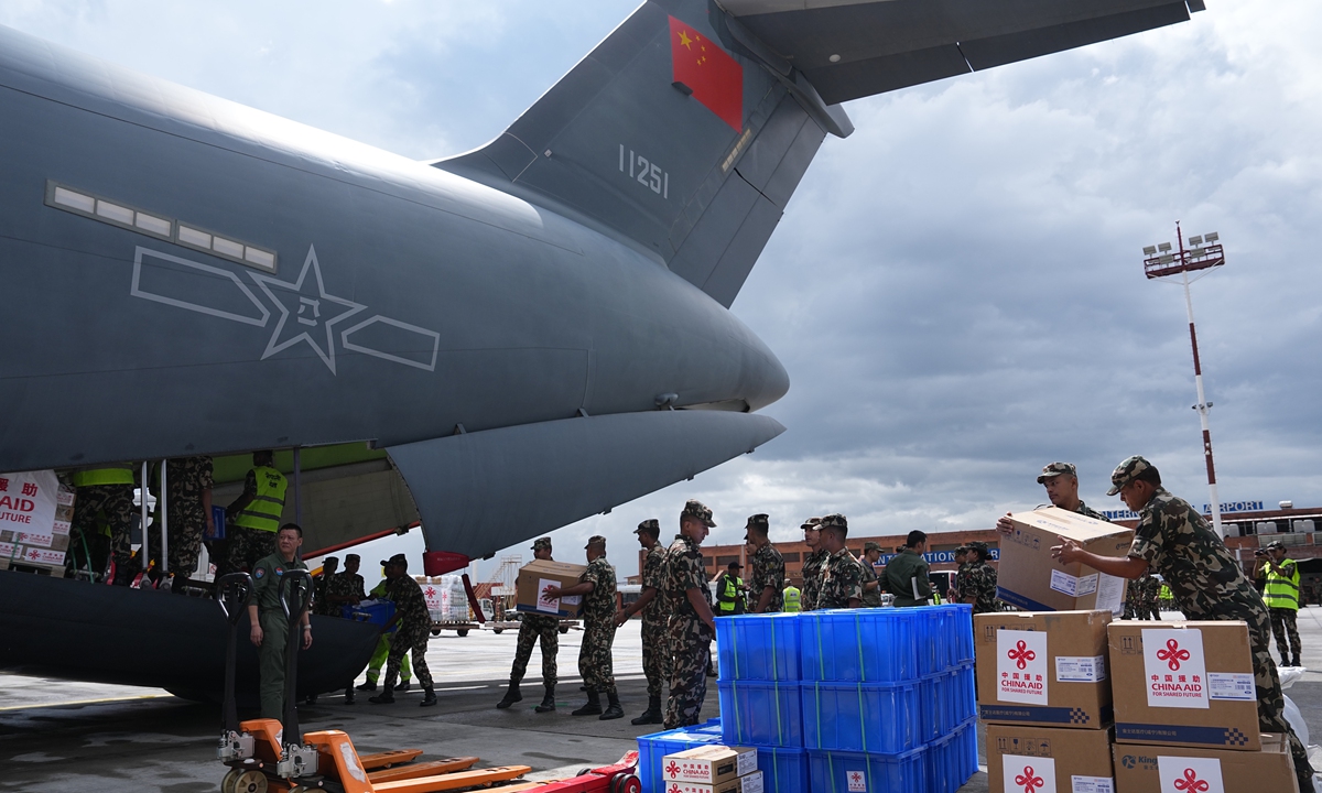 Nepali soldiers unload emergency relief supplies from a Chinese People's Liberation Army Air Force Y-20 transport aircraft at Tribhuvan International Airport in Kathmandu, Nepal, on September 3, 2026. The aircraft delivered China's third batch of emergency aid to Nepal, while 10 DNA forensic experts arrived on the same flight. Photo: VCG