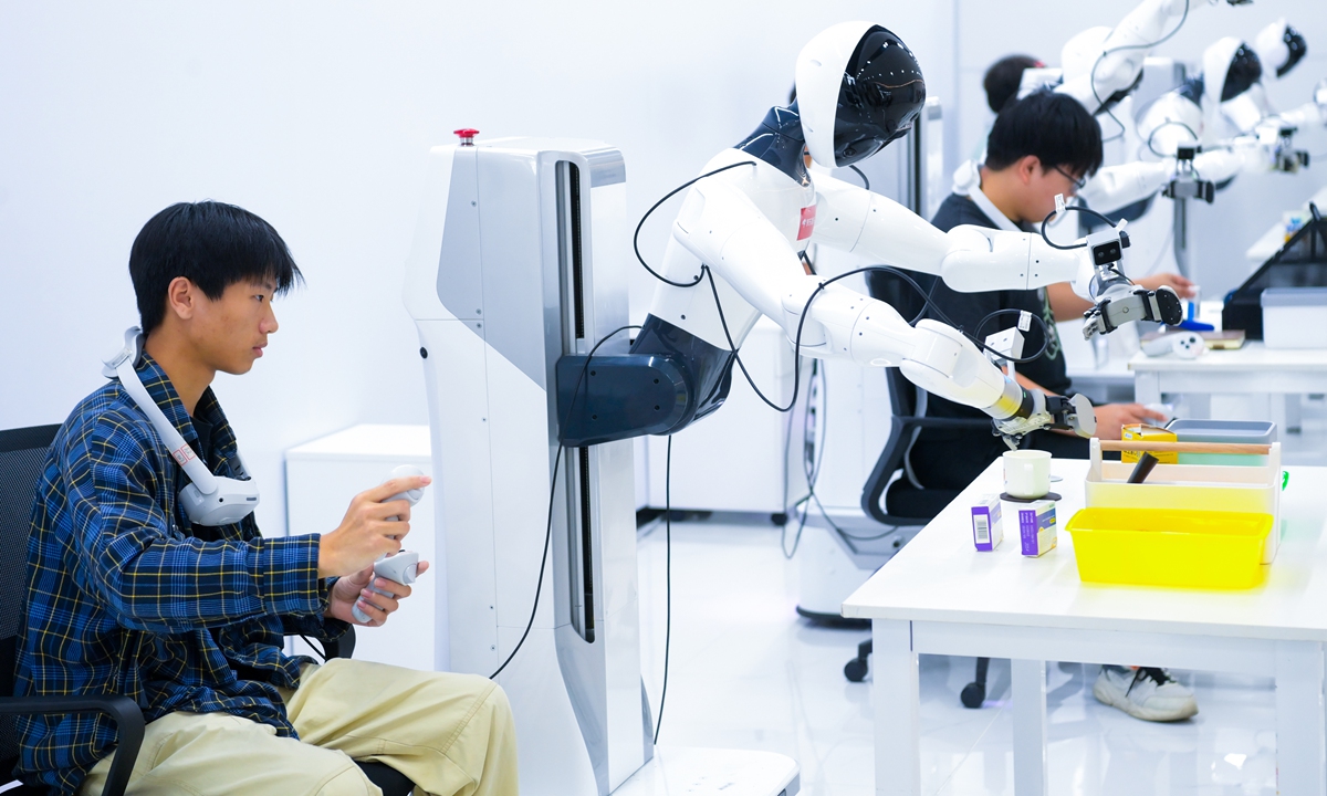 Staff members conduct data collection for various scenarios at a company's embodied?AI robot data collection and training center in Suqian, East China's Jiangsu Province on September 3, 2026. Through real-robot simulation, on-site operations, and human-robot collaboration, the center precisely captures multi-dimensional core data such as vision, motion, and environment data, laying a solid data foundation for the optimization and iteration of embodied-AI models. Photo: VCG